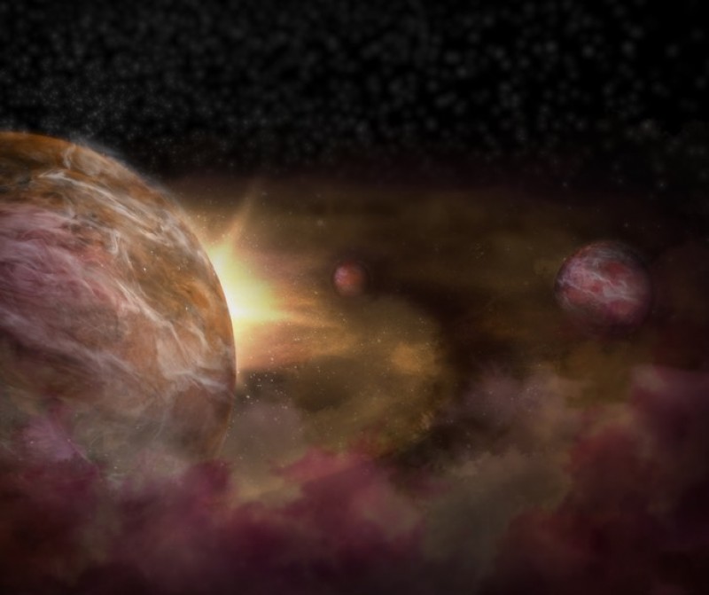 Three planets found around dust-shrouded star